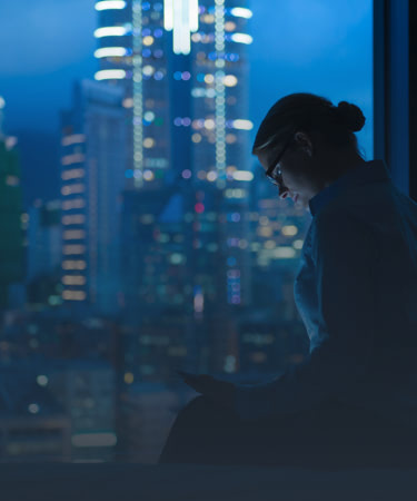 Man working with skyline in the background