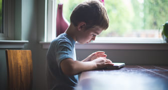 Child using tablet device